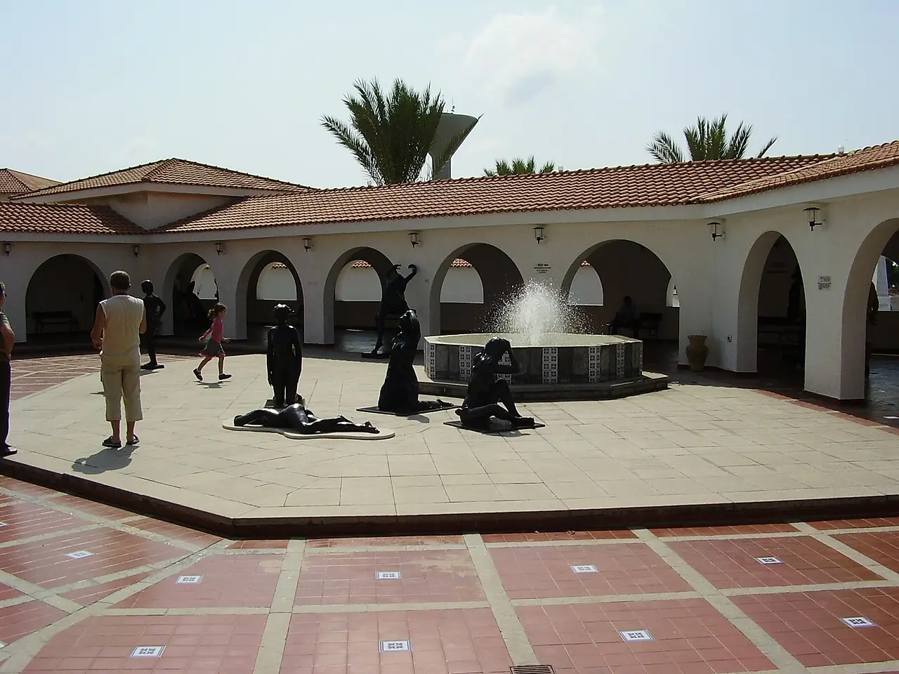 Bronze sculptures around the fountain in the museum's arcaded patio
