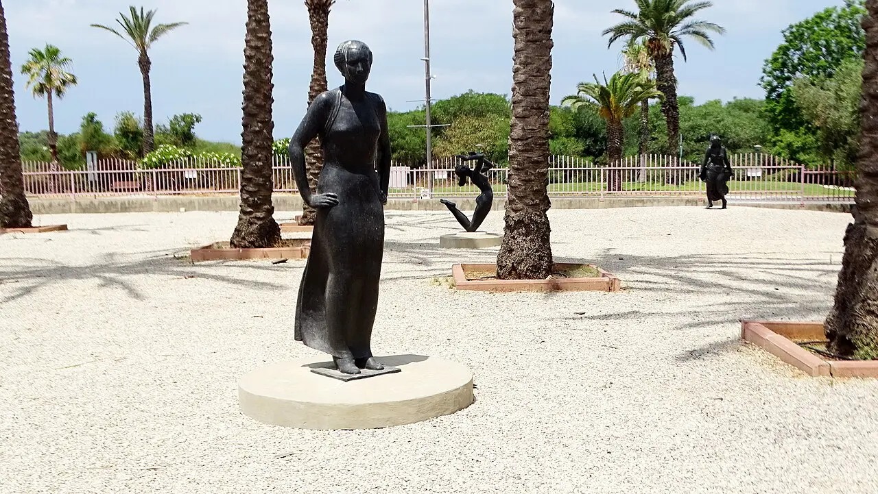 A bronze figure among the palms outside the Ralli Museum