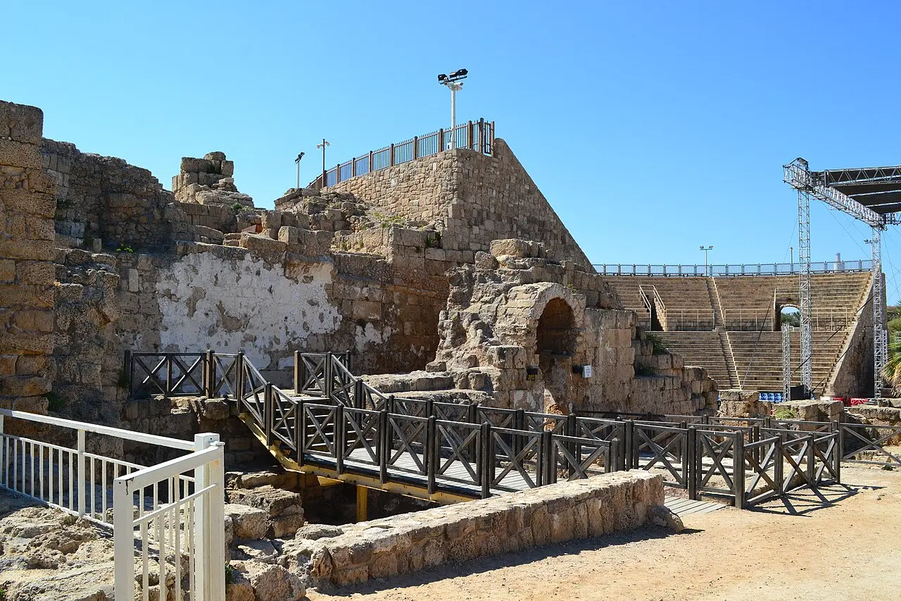 The outer wall of the theatre at Caesarea, with a modern stage rig standing behind it