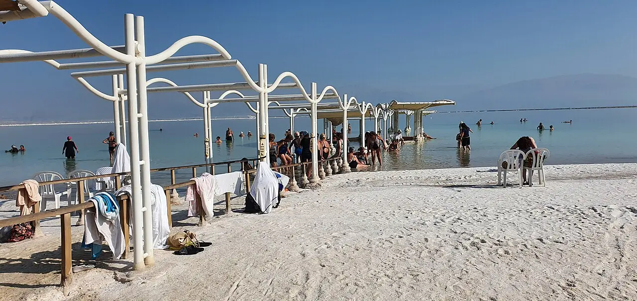 Shade shelters and bathers on the public beach at Ein Bokek