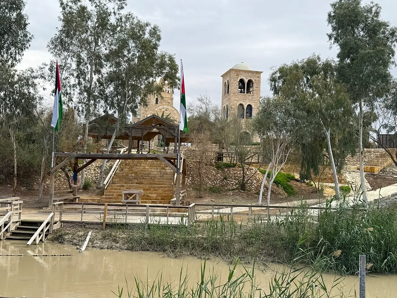 The River Jordan at the baptism site, looking across to the steps and church on the far bank