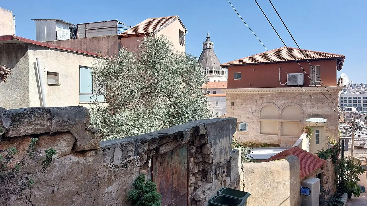 The basilica's dome above the roofs of Nazareth's old town, seen from the street