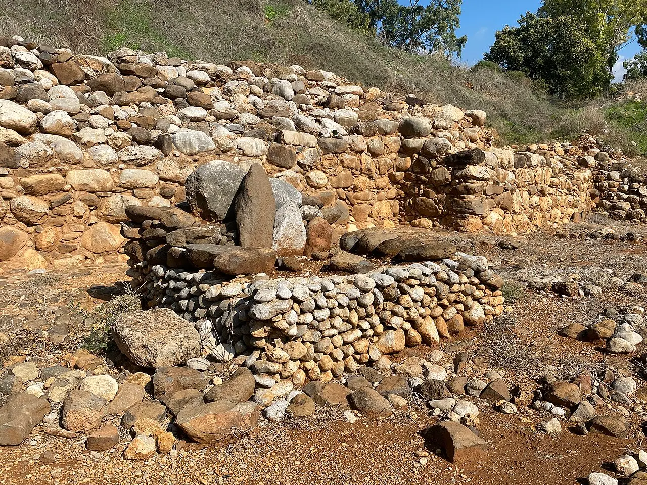 Stone-built remains by the Israelite gate at Tel Dan, a low platform in front of the wall