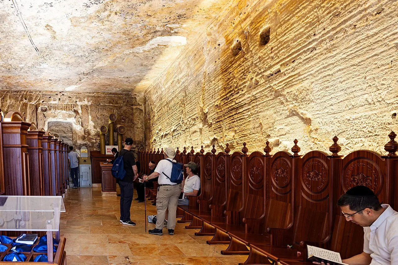 Inside Elijah's Cave in Haifa, wooden screens along the rock wall