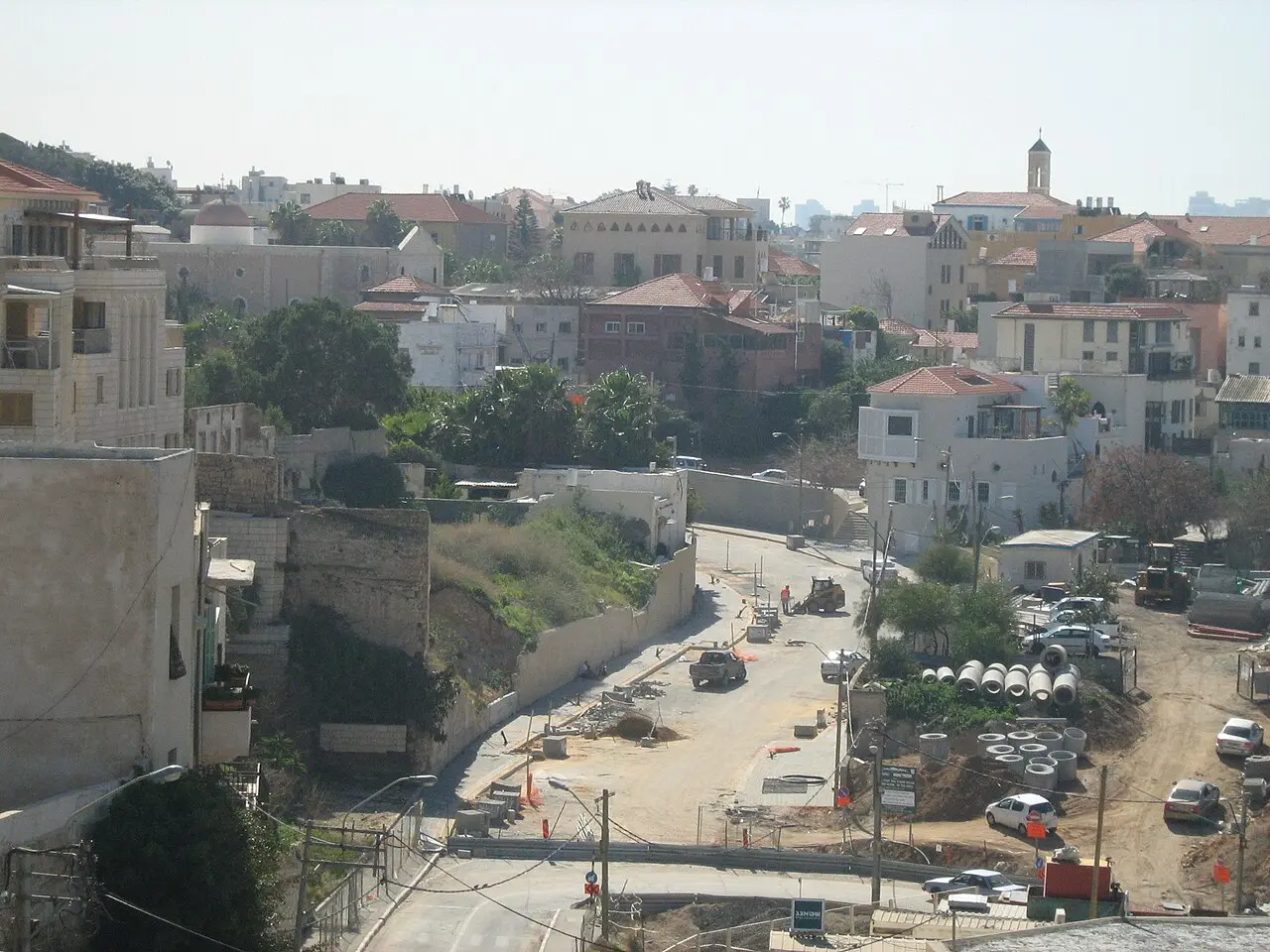 Rooftops and a road in Ajami, a minaret on the skyline