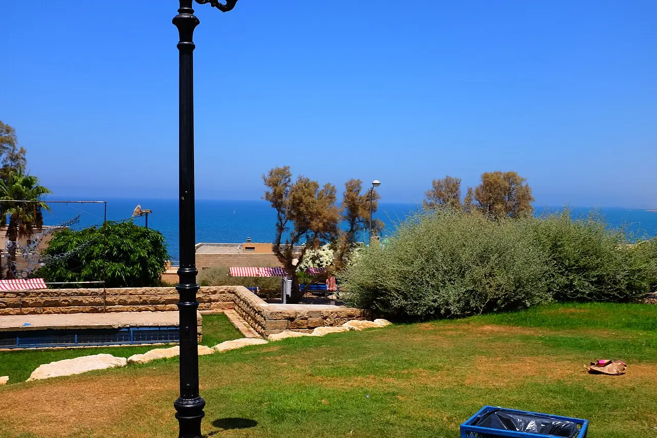 The lawn at the top of HaPisga Garden in Jaffa, with the sea beyond