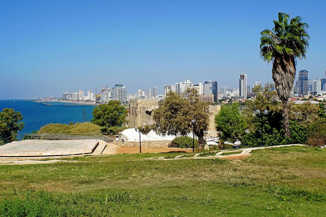 Tel Aviv's shoreline and towers seen from the lawn of HaPisga Garden in Jaffa