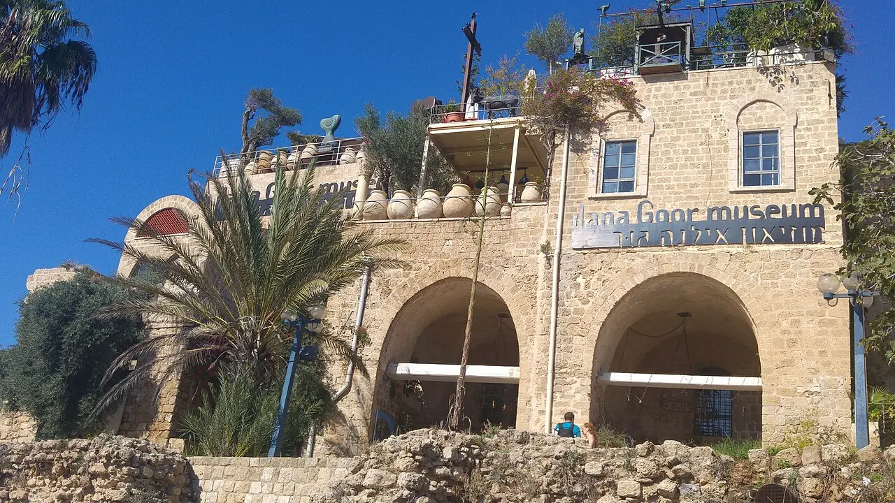 The arched front of the Ilana Goor Museum, its name across the wall