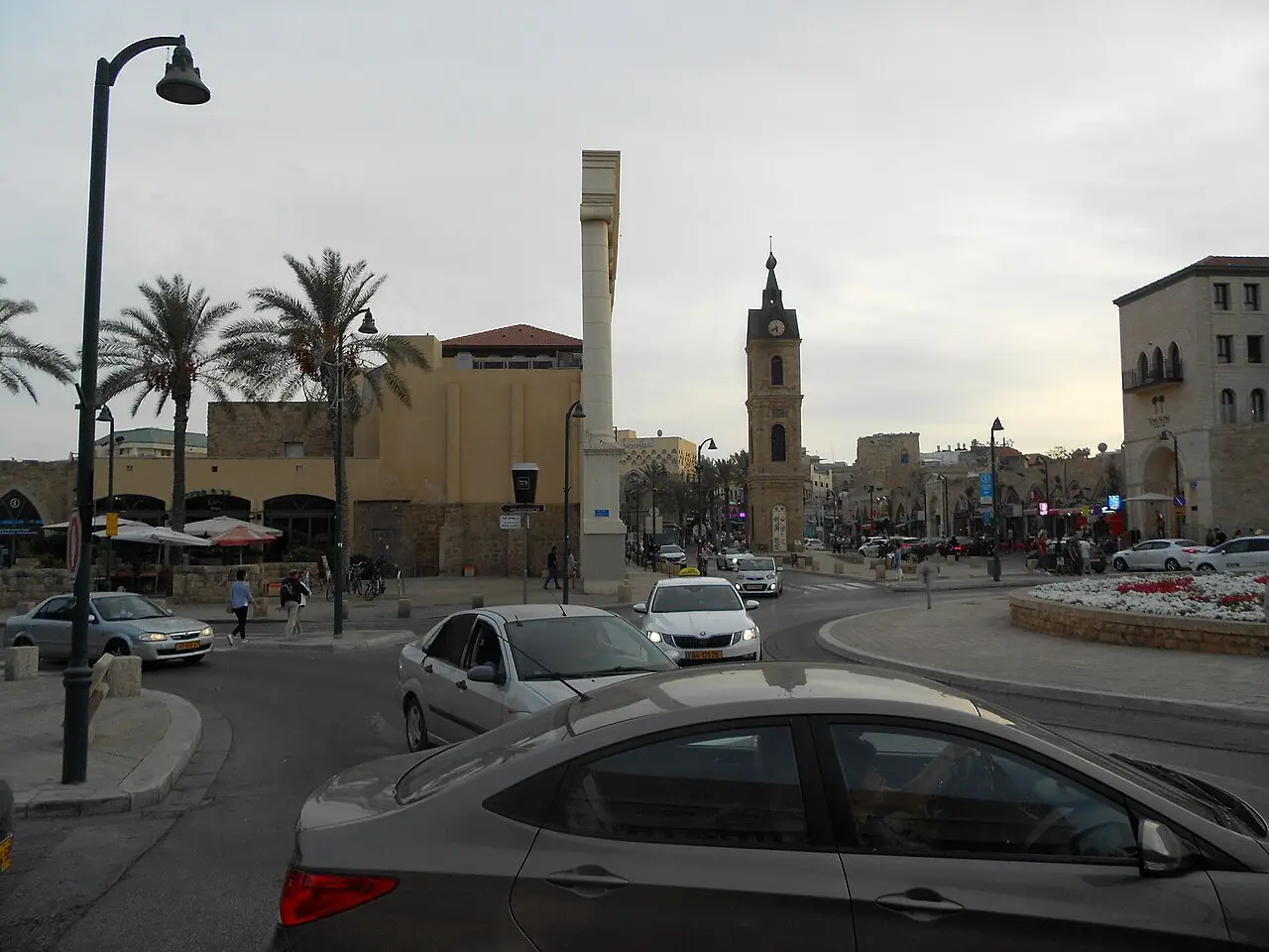 Clock Tower Square in Jaffa, the tower at its centre among palms and traffic