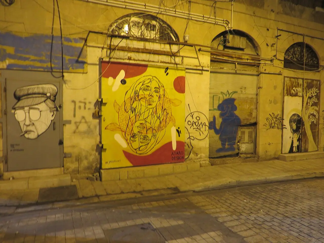 Painted shop shutters in the flea market's lanes after closing time