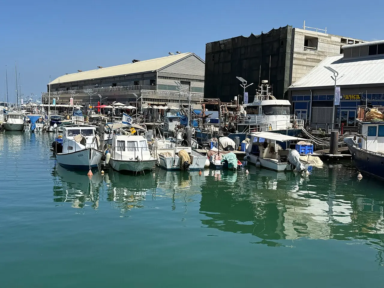 Boats moored in front of the old port warehouses in Jaffa