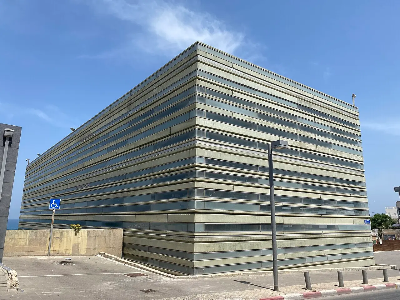 The banded concrete and glass walls of the Peres Center in Jaffa