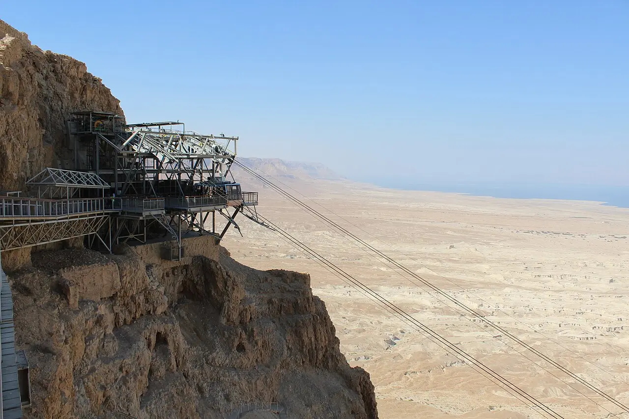 The cable car's upper station clinging to the cliff at Masada, the Dead Sea plain beyond