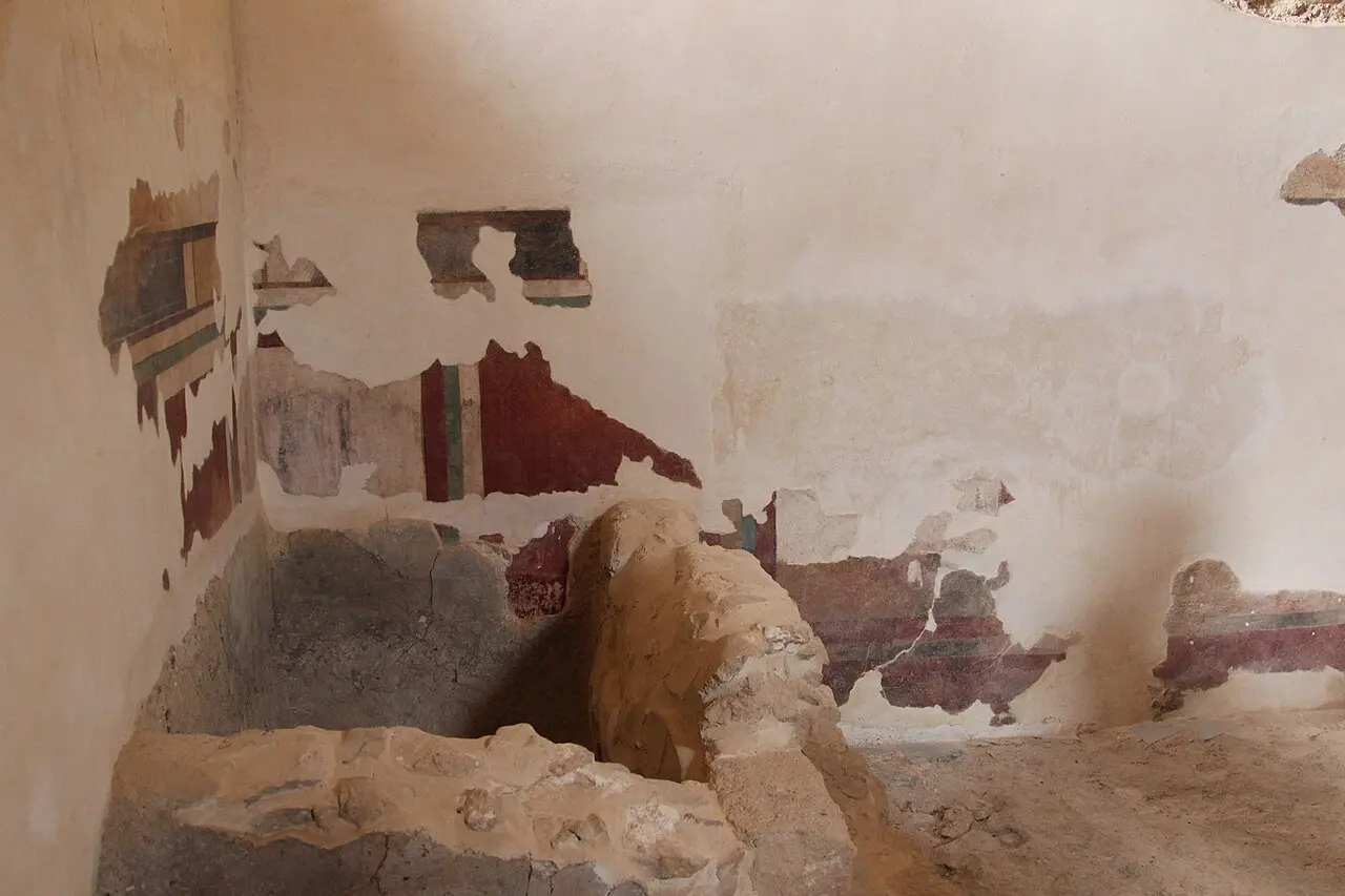 Fragments of coloured plaster still on the walls of the bathhouse at Masada