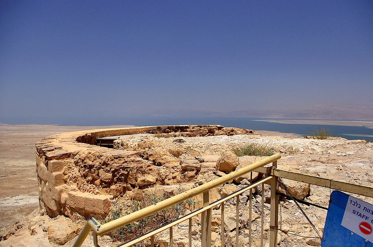 The curved edge of the palace's upper terrace, with the Dead Sea plain beyond