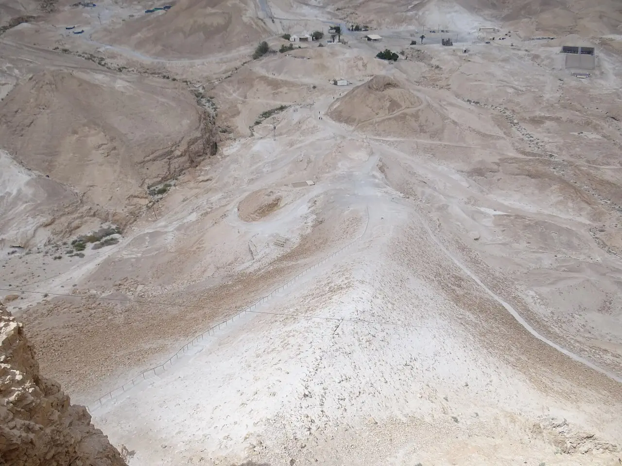 The pale spine of the Roman ramp below the walls of Masada