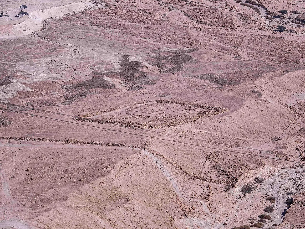 The square outline of a Roman siege camp on the desert floor below Masada