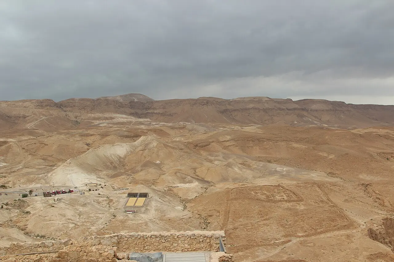 Roman camps traced in low stone walls on the plain below Masada