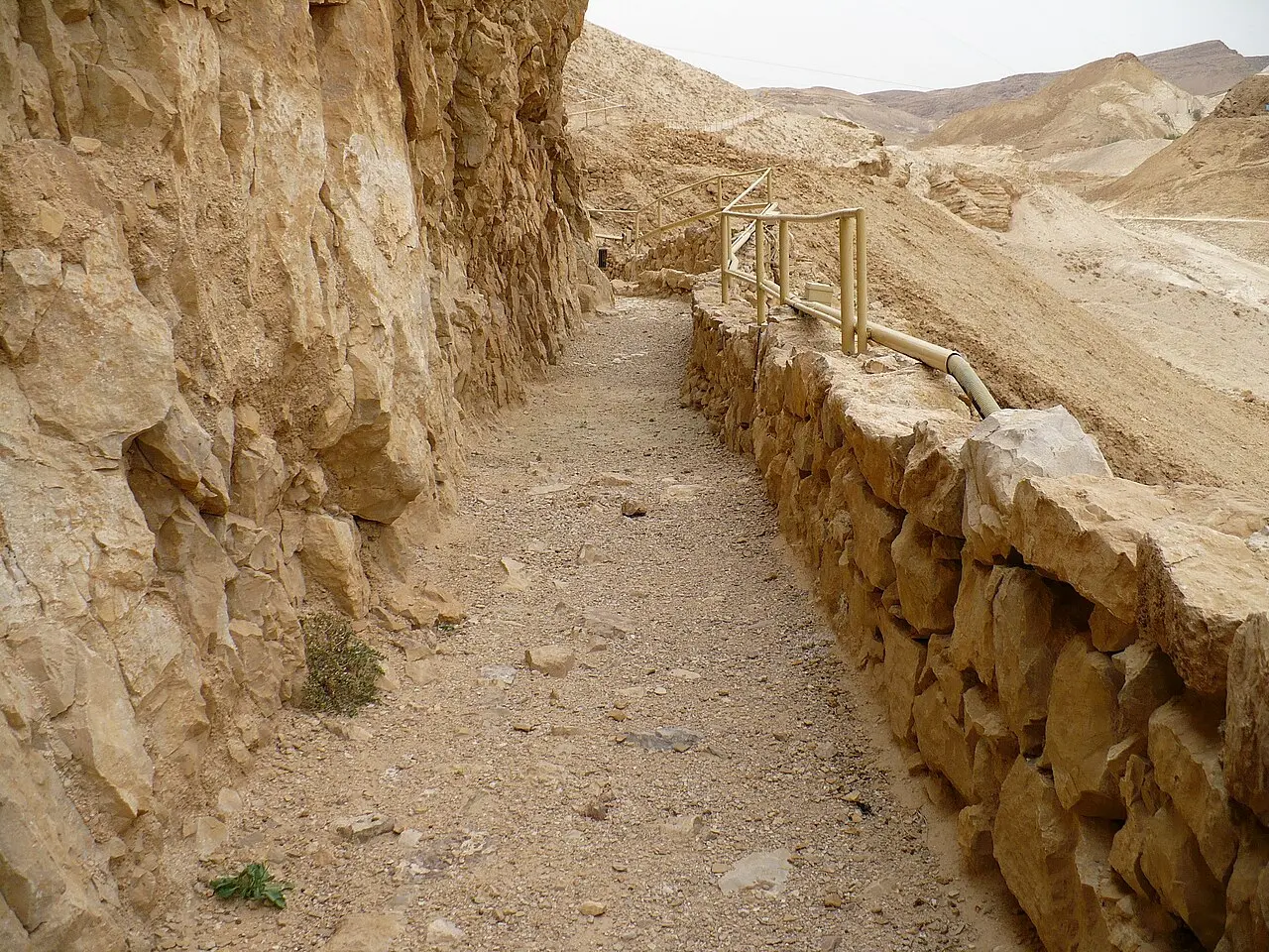 The channel of the upper aqueduct running along the cliff below Masada