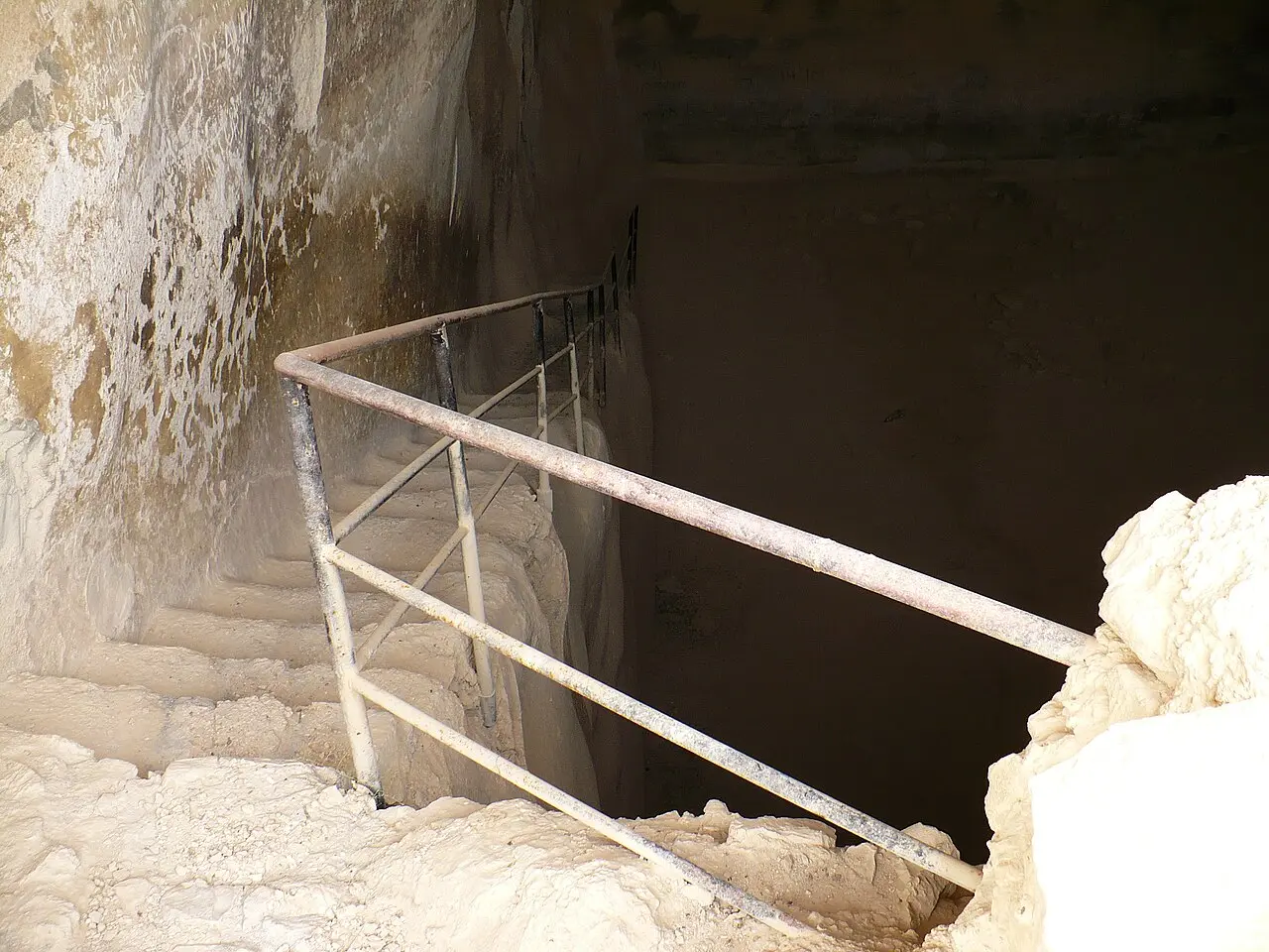 Steps with a handrail descending into one of Masada's rock-cut cisterns