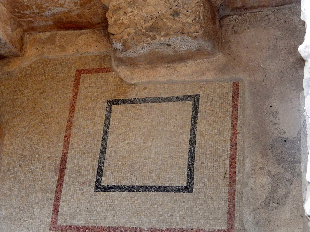 A plain mosaic panel with a black frame in a room of the Western Palace