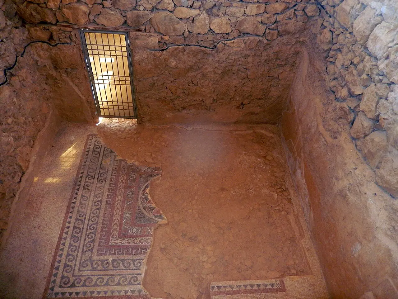A plastered room in the Western Palace with a patterned mosaic at its entrance