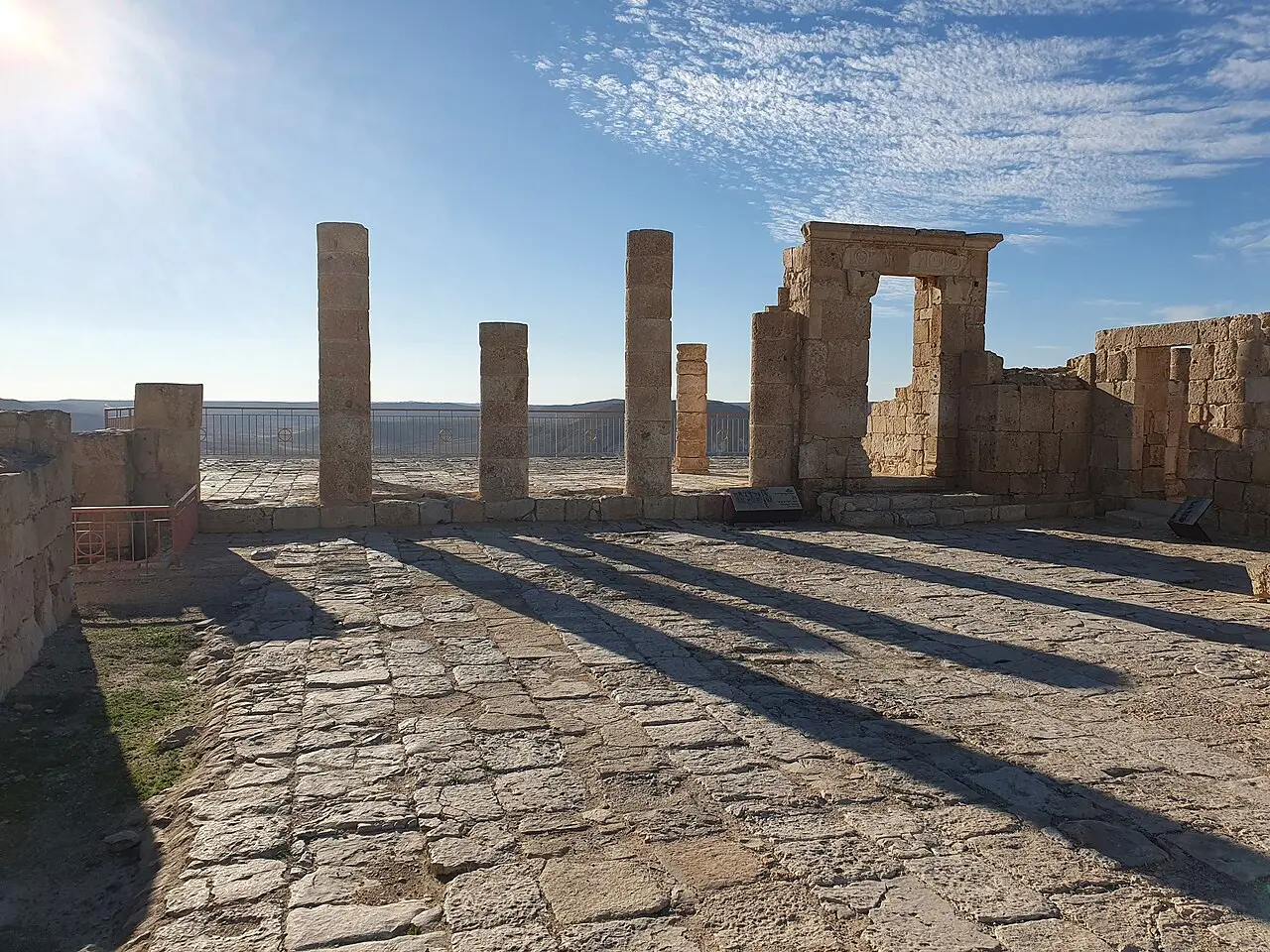 Columns and a doorway of the temple on Avdat's acropolis, casting long shadows