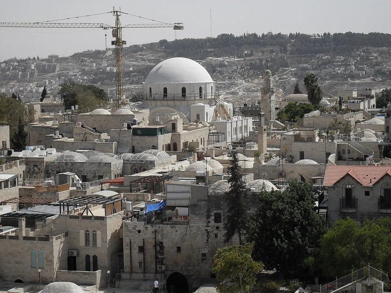 The Hurva's white dome rising among the roofs of the Jewish Quarter in 2009, a crane still beside it