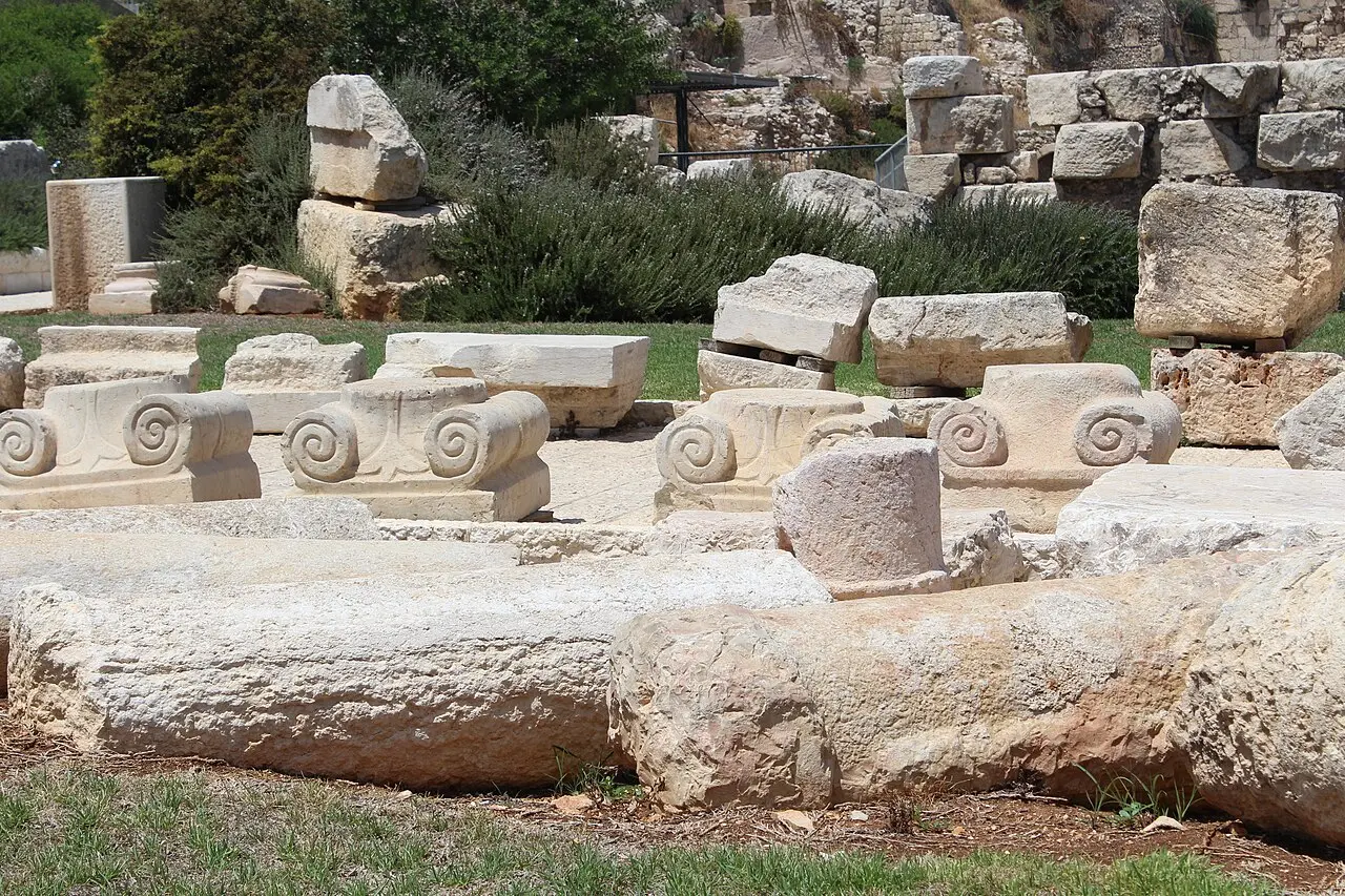 Fallen column drums and carved stones laid out in the archaeological park