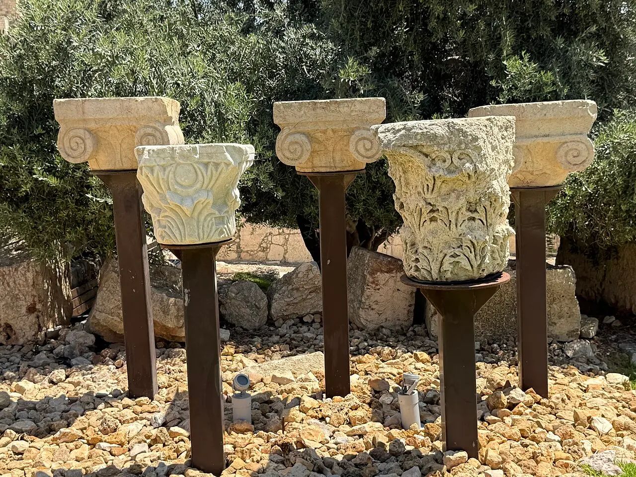 Carved stone capitals mounted on posts in the archaeological park
