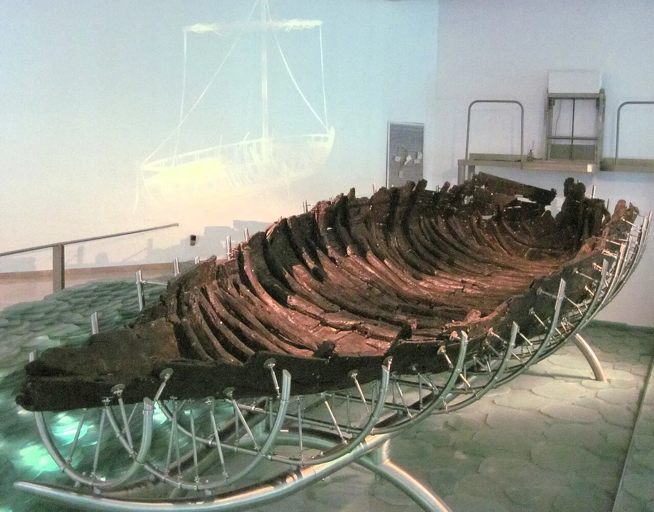 The ancient boat's hull on its steel cradle at the museum in Ginosar