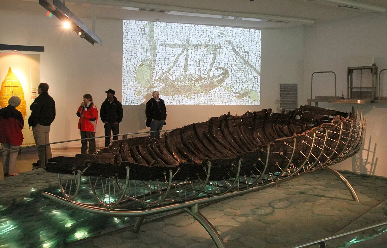 Visitors beside the boat in its gallery at the Yigal Allon Centre