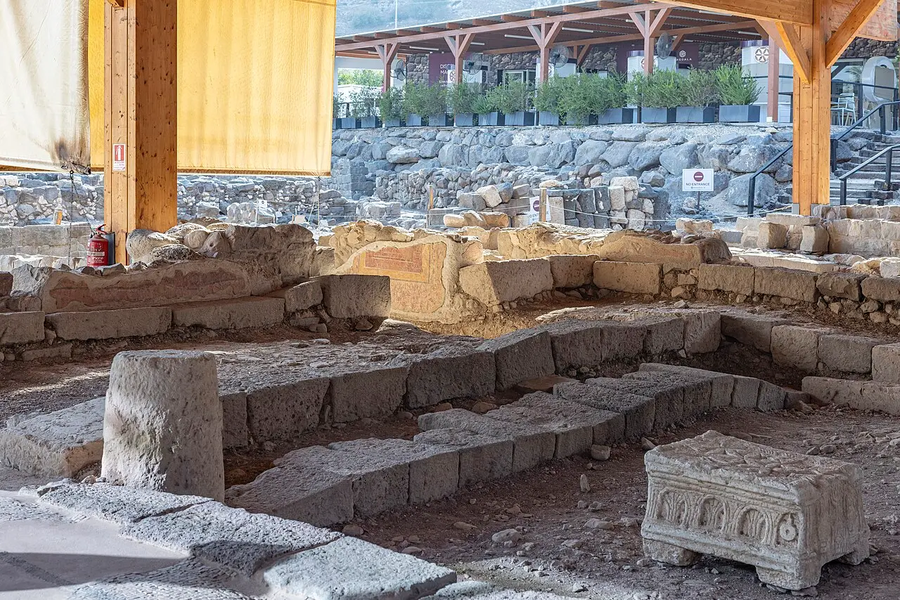 The ancient synagogue at Magdala under its shelter, the carved stone block standing on its floor