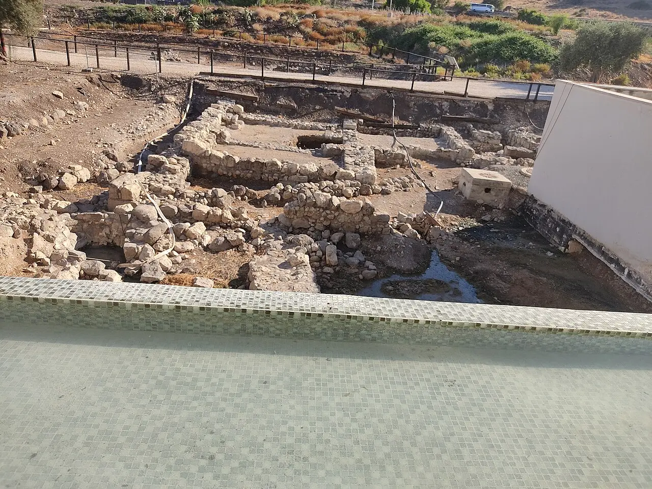 The excavated streets and buildings of ancient Magdala beside the modern centre