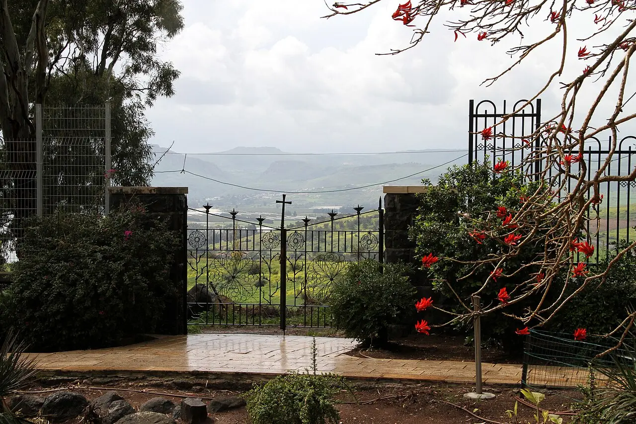 The iron gate to the Mount of Beatitudes compound, the lake in the haze beyond