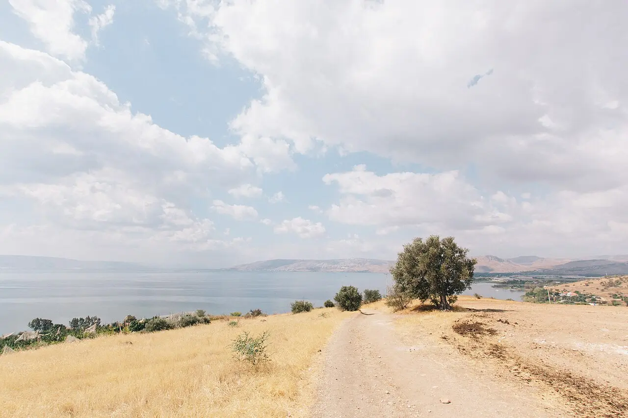 A dirt track across the dry slope of the Mount of Beatitudes, the lake in the distance