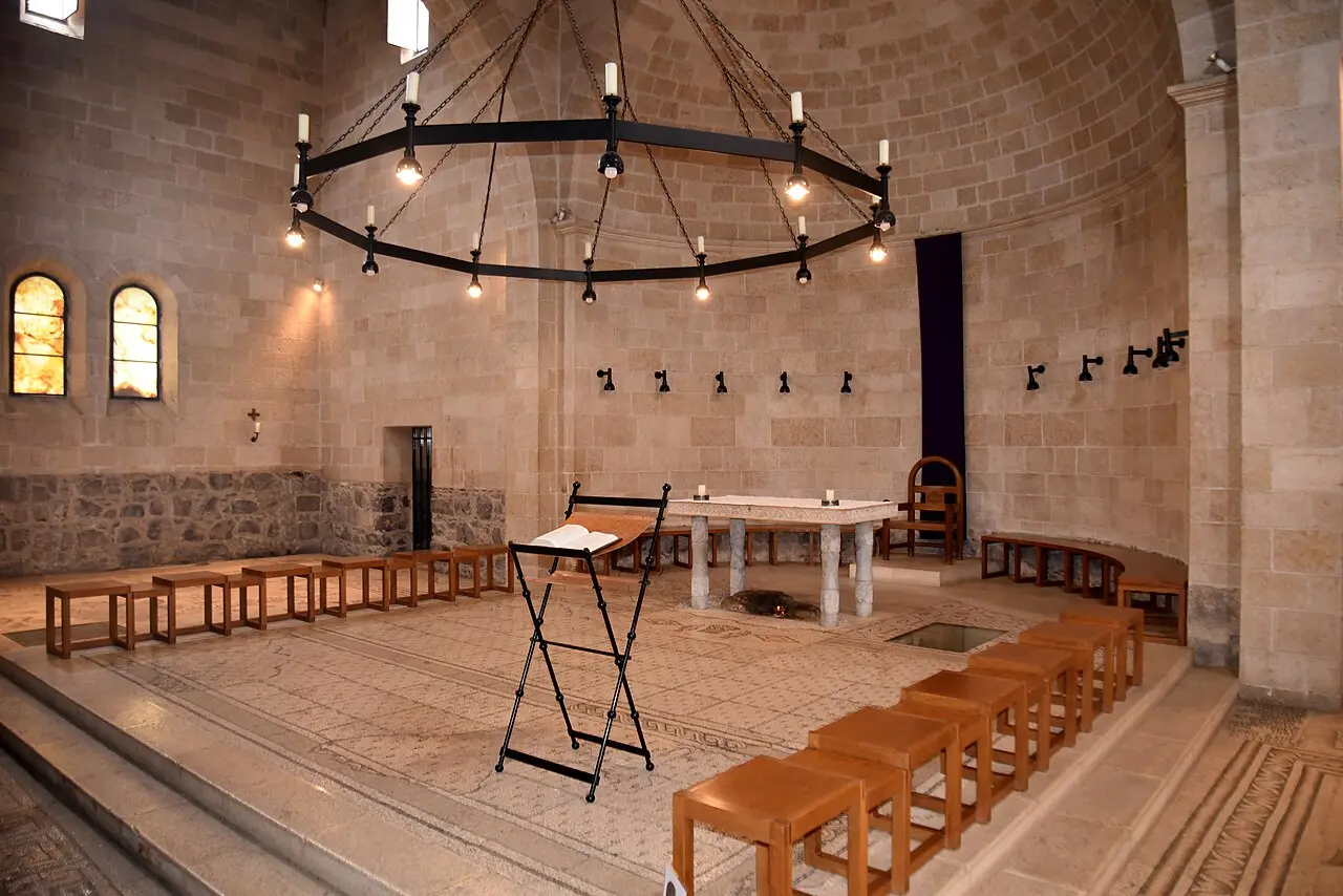 The chancel of the Church of the Multiplication, the altar under an iron chandelier