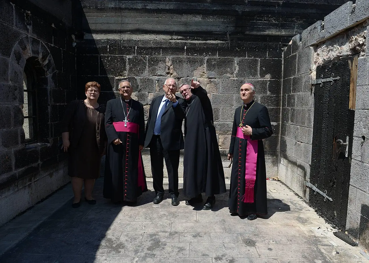 President Reuven Rivlin and church leaders in a fire-blackened room of the Tabgha compound after the 2015 arson