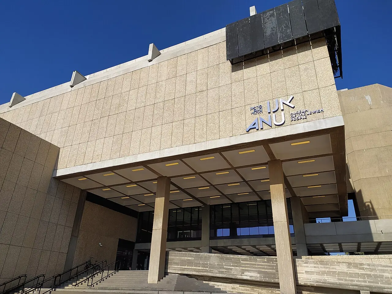 The concrete exterior of ANU, the museum's name on its front