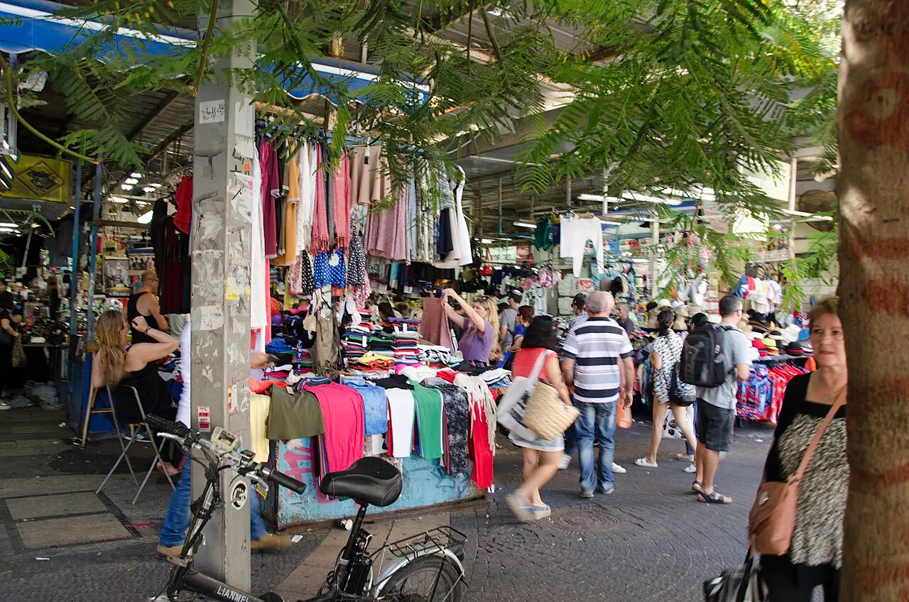 The main lane of the Carmel Market, clothing stalls on both sides