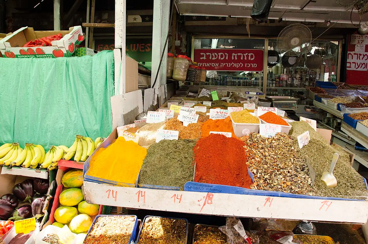 Heaps of spices and bunches of bananas on a stall in the Carmel Market